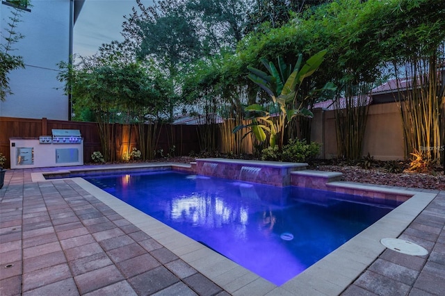 view of swimming pool featuring a grill and pool water feature