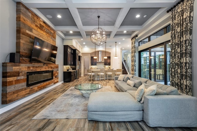 living room with coffered ceiling, beam ceiling, hardwood / wood-style floors, and a notable chandelier