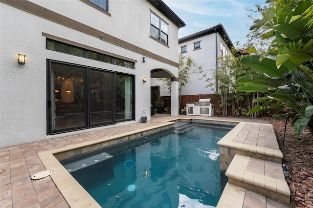 view of pool with a patio and pool water feature