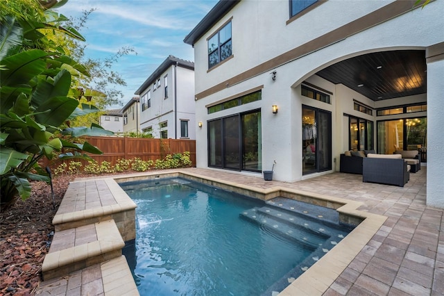 view of swimming pool featuring a patio and an outdoor hangout area