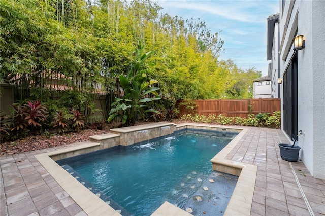 view of pool featuring pool water feature and a patio area