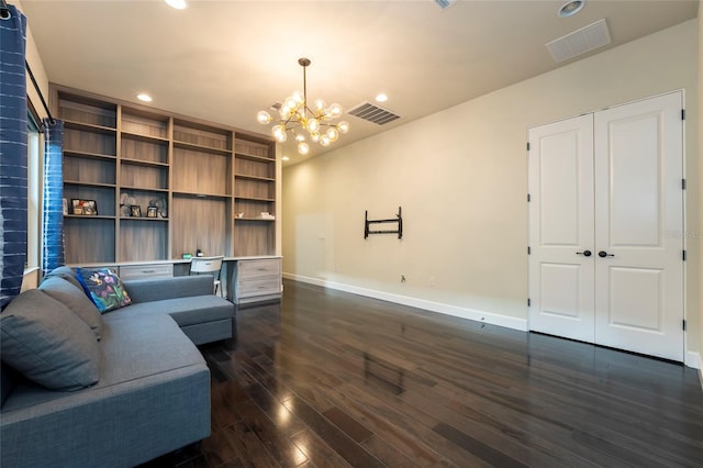 living room featuring an inviting chandelier and dark wood-type flooring