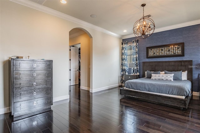 bedroom with crown molding, a chandelier, and dark wood-type flooring