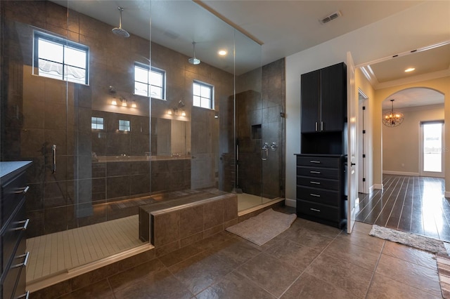 bathroom with walk in shower, plenty of natural light, and tile floors