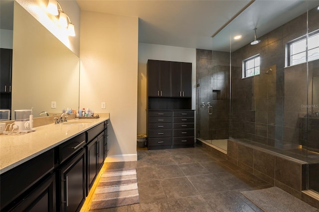 bathroom with an enclosed shower, tile flooring, and vanity