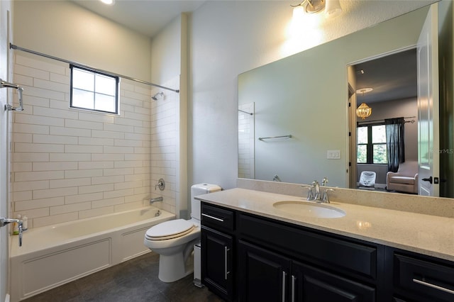 full bathroom featuring tile flooring, tiled shower / bath, vanity, and toilet