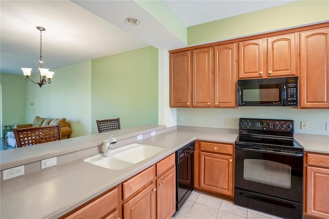 kitchen with pendant lighting, light tile flooring, black appliances, sink, and a notable chandelier