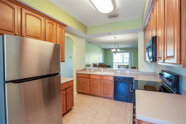 kitchen featuring decorative light fixtures, black appliances, light tile floors, sink, and ceiling fan