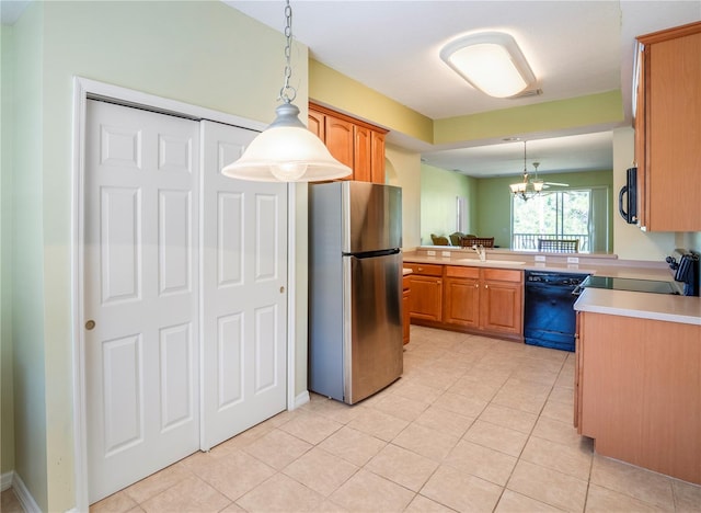 kitchen featuring hanging light fixtures, black appliances, sink, and light tile flooring