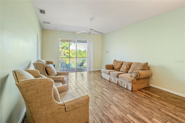 living room with light hardwood / wood-style flooring and ceiling fan