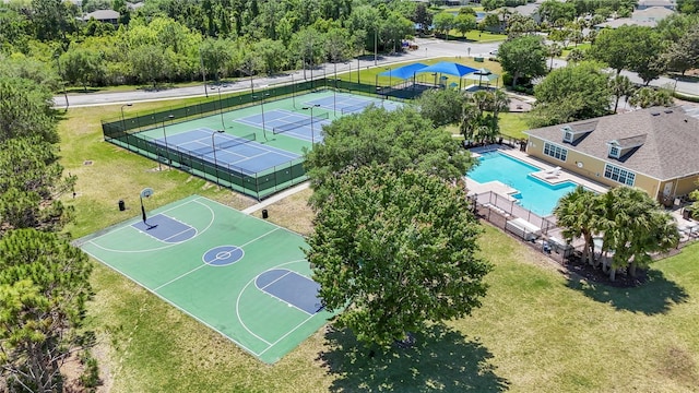 view of sport court with a yard, tennis court, and a community pool