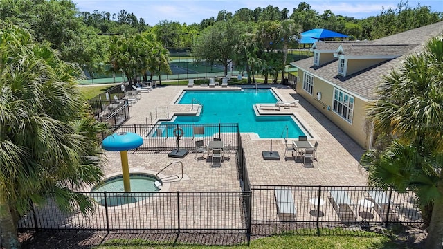 view of pool featuring a hot tub and a patio