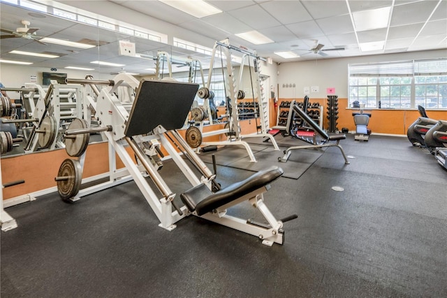 gym with ceiling fan and a paneled ceiling