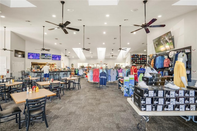 interior space featuring high vaulted ceiling, carpet, and ceiling fan