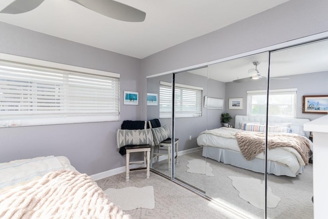 carpeted bedroom with ceiling fan and a closet