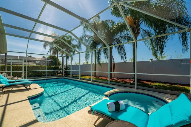 view of swimming pool with glass enclosure