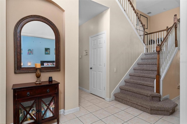 stairway featuring light tile floors