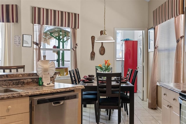 dining room featuring a healthy amount of sunlight and light tile flooring