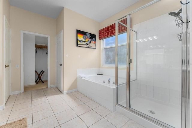 bathroom featuring tile flooring and shower with separate bathtub