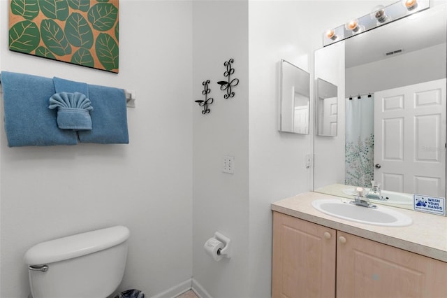 bathroom with toilet and vanity