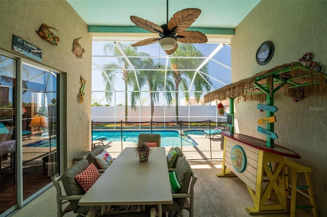 carpeted dining space with ceiling fan