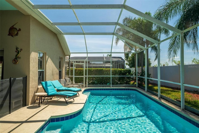 view of swimming pool with a patio and a lanai