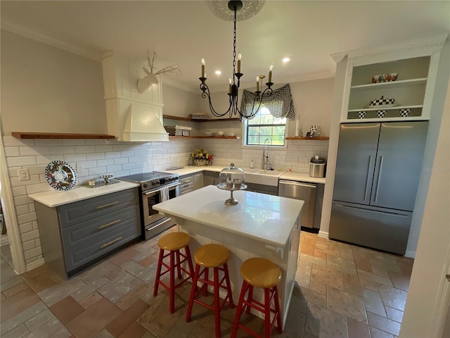 kitchen with a kitchen bar, dark tile flooring, backsplash, and high end appliances