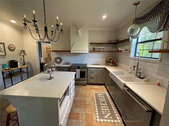 kitchen with light tile flooring, backsplash, gray cabinets, hanging light fixtures, and stainless steel appliances