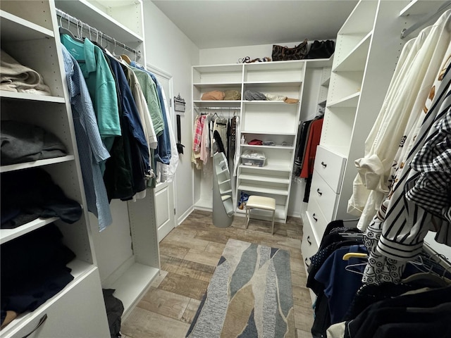 spacious closet featuring light hardwood / wood-style flooring