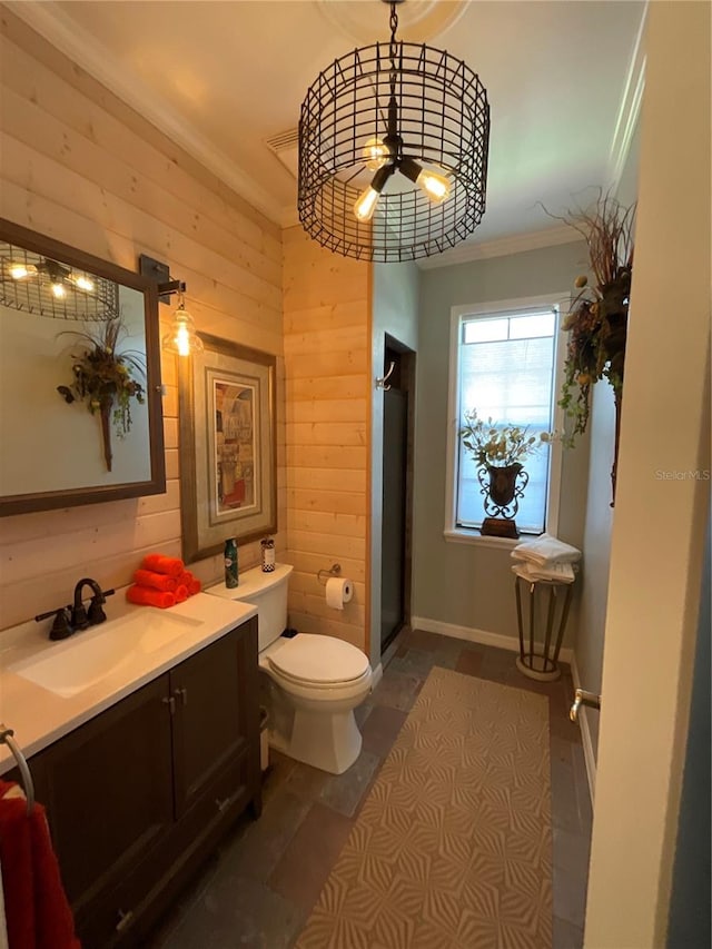 bathroom featuring wooden walls, vanity, ornamental molding, toilet, and ceiling fan