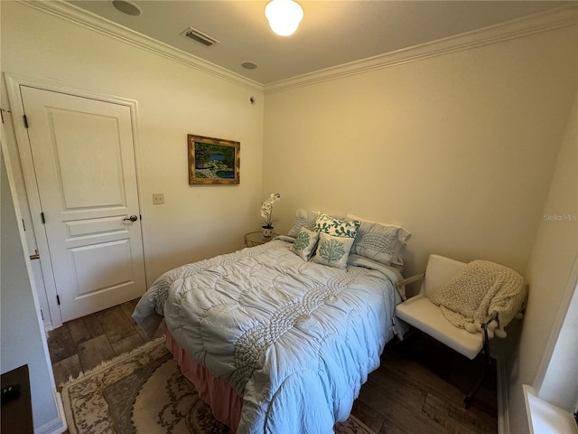 bedroom featuring crown molding and dark wood-type flooring