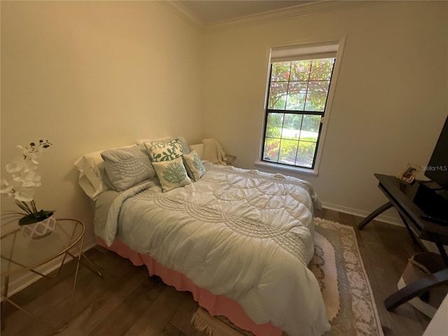 bedroom featuring crown molding and dark wood-type flooring