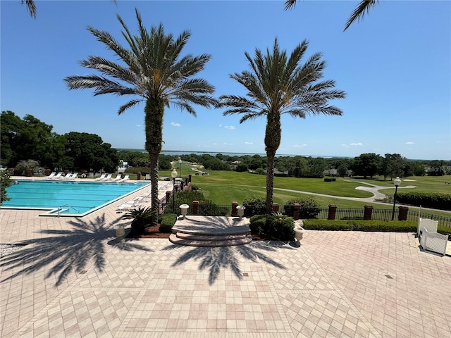 view of swimming pool with a patio area and a yard