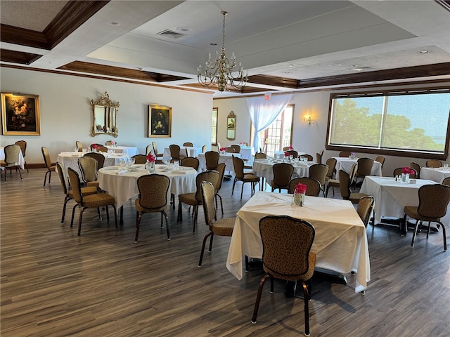 dining area featuring a raised ceiling, dark wood-type flooring, and a chandelier