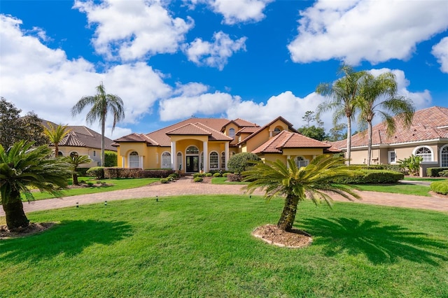 mediterranean / spanish house featuring a front lawn