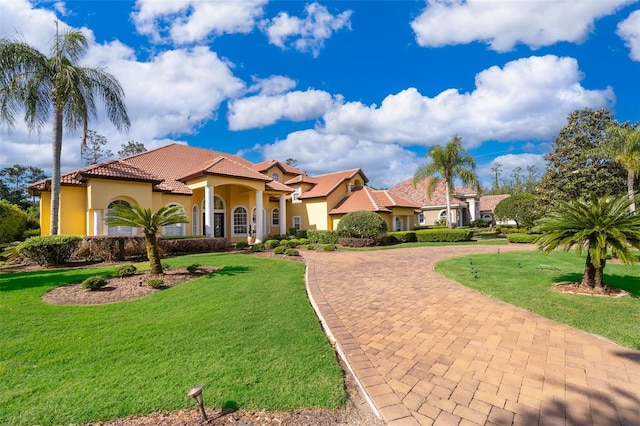 mediterranean / spanish-style home featuring a front lawn