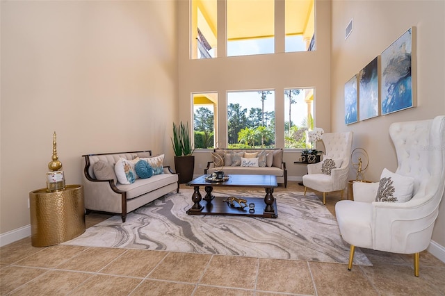 living room featuring light tile flooring and a towering ceiling