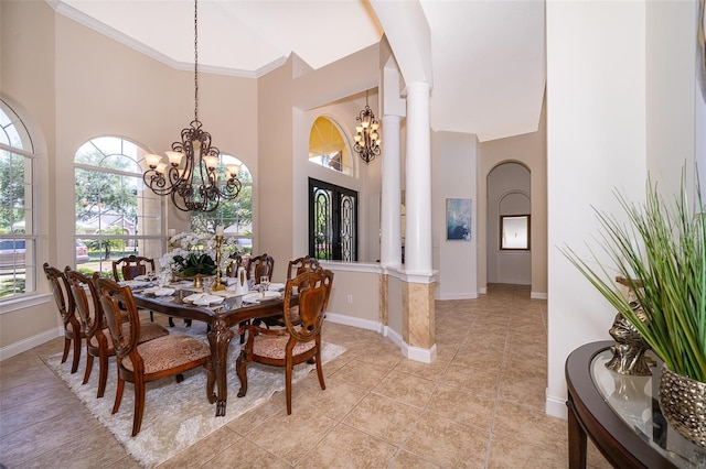 tiled dining area with crown molding, a towering ceiling, and a notable chandelier