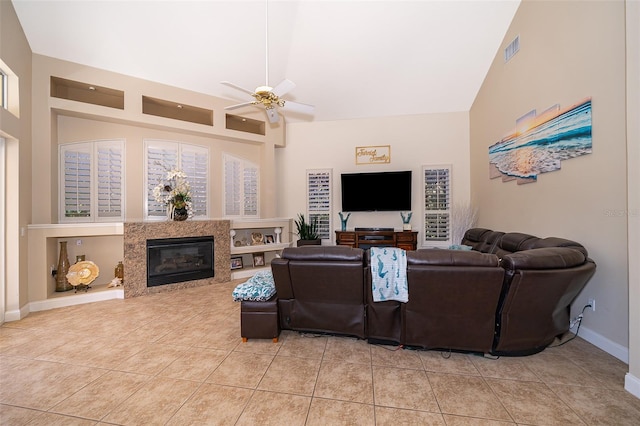 living room with high vaulted ceiling, ceiling fan, and light tile floors