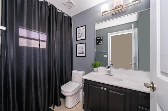 bathroom featuring toilet, tile flooring, a textured ceiling, and large vanity