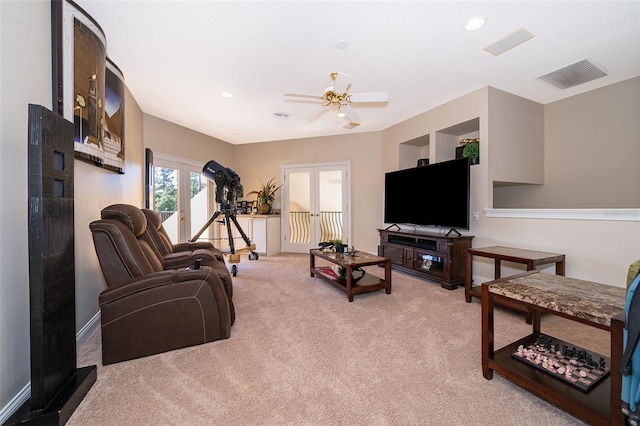 living room featuring light colored carpet, french doors, and ceiling fan