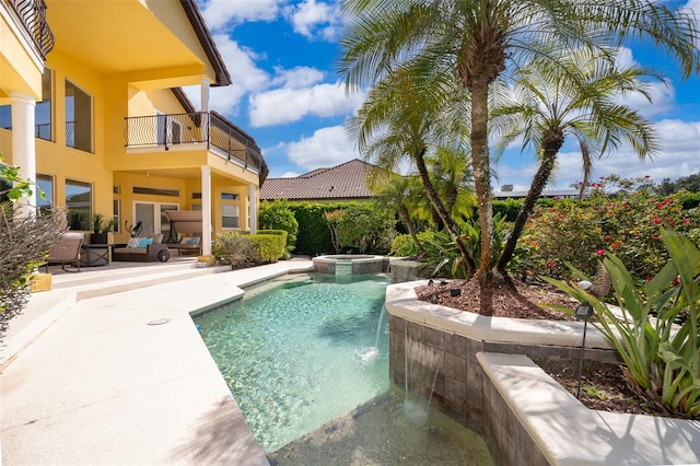 view of pool featuring a patio, an outdoor living space, an in ground hot tub, and pool water feature