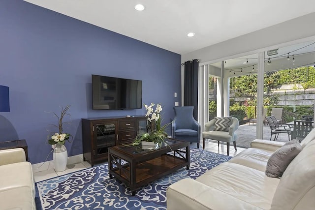 living room with tile flooring and a healthy amount of sunlight