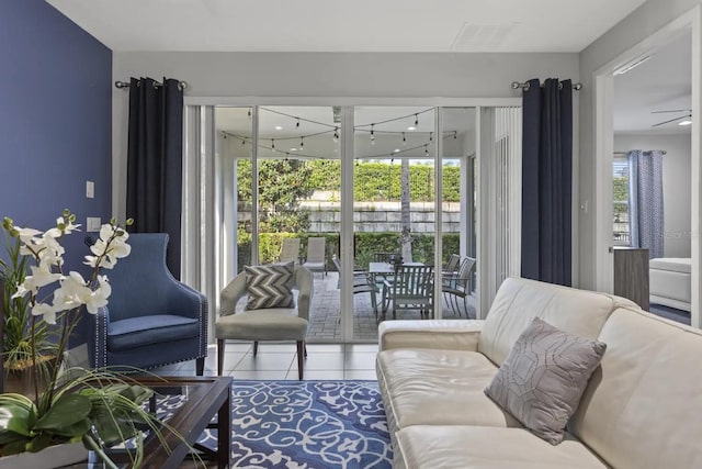 tiled living room featuring ceiling fan