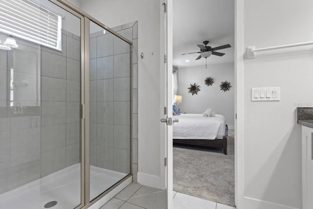 bathroom with a shower with door, vanity, tile flooring, and ceiling fan