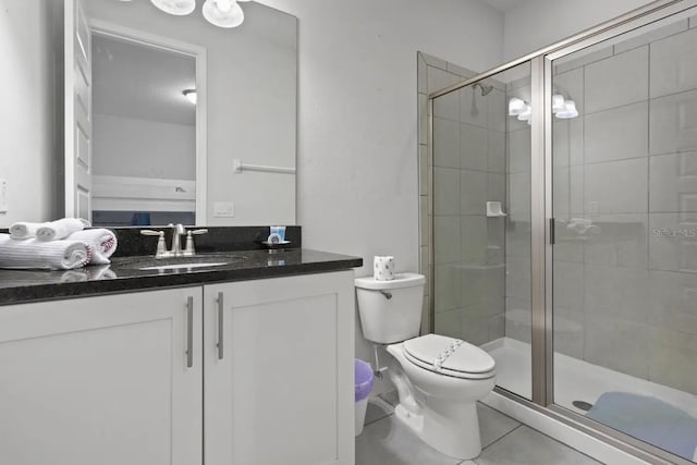 bathroom with a shower with door, toilet, tile floors, and oversized vanity