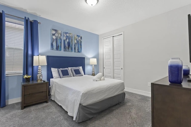 bedroom with dark colored carpet and a closet