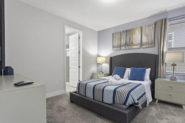 carpeted bedroom featuring connected bathroom