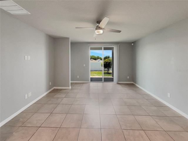 spare room featuring ceiling fan and light tile floors