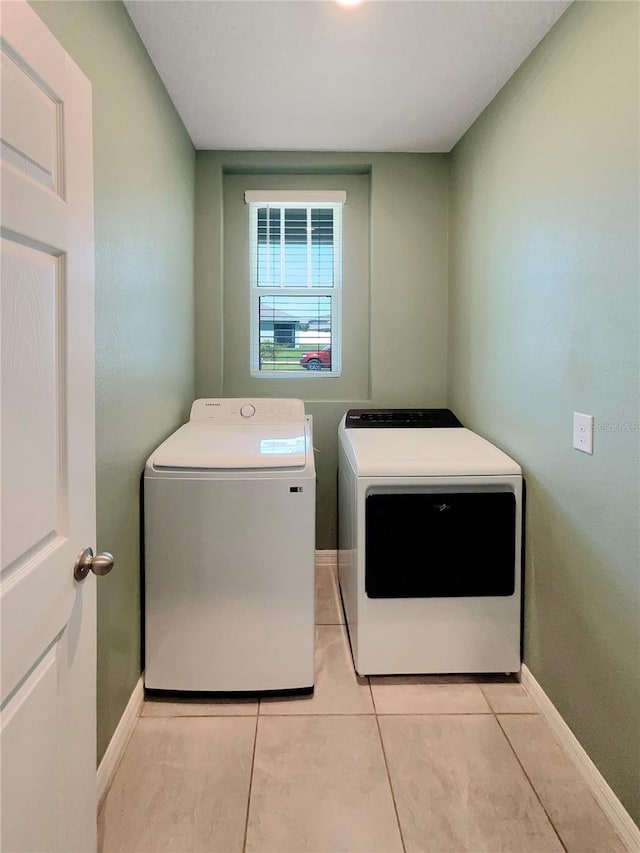 laundry area featuring independent washer and dryer and light tile floors